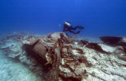 Maritime archaeologist investigates the tangled wreckage of the USS Macaw at Midway.