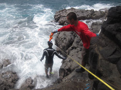 Team members Patrick Springer and Russell Stoner at work on the rocky shoreline of Nihoa. 