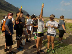 Kaiser High School students measure wind speed at Kaʻena Point.