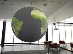 NOAA’s Science on a Sphere projection system hangs seemingly in midair in the lobby