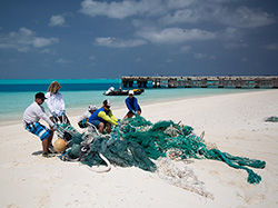 The Marine Debris Team hauls discarded fishing nets for removal at Midway Atoll.