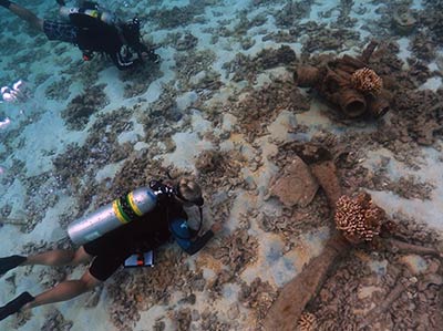 NOAA maritime archaeologists survey the remains of a sunken World War II era aircraft at Midway Atoll, credit: NOAA/PMNM