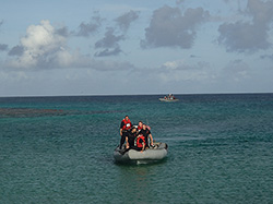 Navy Crew from the USS Comstock arrive to pick up the crew at Laysan.   