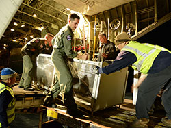 Two female Hawaiian monk seals are returned to the Northwestern Hawaiian Islands.U.S. Coast Guard crew members load the seals onto the HC-130 for transport.