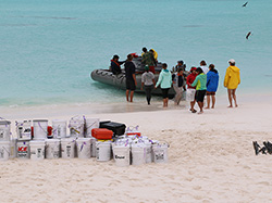 The team off-loads the seals and other supplies at Kure Atoll State Wildlife Sanctuary. 