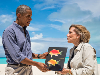 Famed undersea explorer Sylvia Earle presents President Obama with a picture of the fish that bears his name during his visit to Midway Atoll in September 2016.
