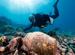 Dr. Kelly Gleason investigates a ginger jar at the Two Brothers shipwreck site.