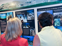 Visitors take a look at the Lost on a Reef exhibit panels at the Nantucket Whaling Museum.