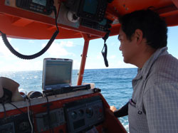 Archaeologist Bert Ho watches the monitor while conducting magnetometer survey at Midway Atoll.