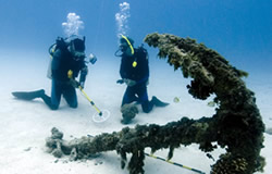 Hans Van Tilburg and Sean Corson investigate an anchor in Welles Harbor at Midway Atoll.
