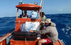 Jason Burns and  Michael Krivor collect data as Jason Kehn cox'ns HI-2 at Midway Atoll.