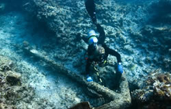 Kelly Gleason investigates an early 19th century anchor at the Hermes shipwreck site.