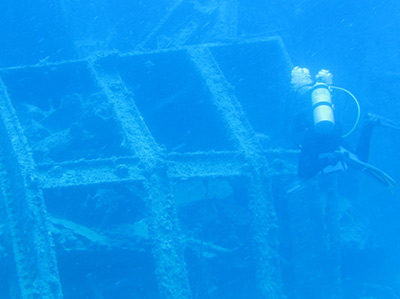 Maritime archaeologist Melissa Price investigates the skylight structure of USNS <em>Mission San Miguel</em> at Maro Reef.