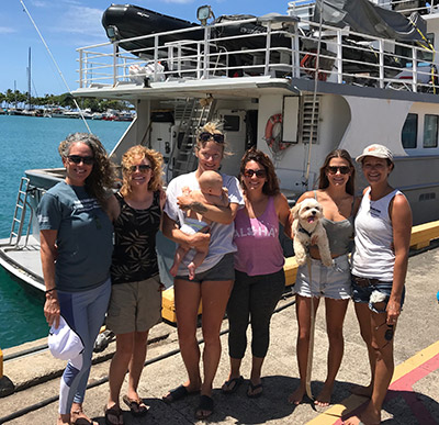 The wāhine researchers and Searcher crew are greeted by ʻohana at Kewalo. Left to Right: Malia Evans,
Brittany Evans, Jules Hartl with daughter Milo, Eden Zang, Paige Wernli carrying puppy and
Gillian Wysock.