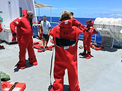 All ship crew and scientists must practice donning their survival suits.