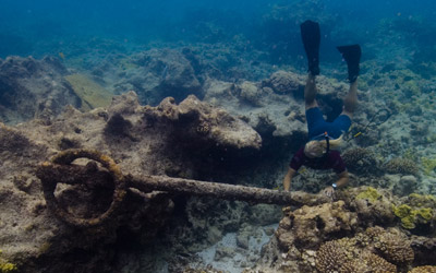 Maritime archaeologist investigates an anchor at the Two Brothers shipwreck site.